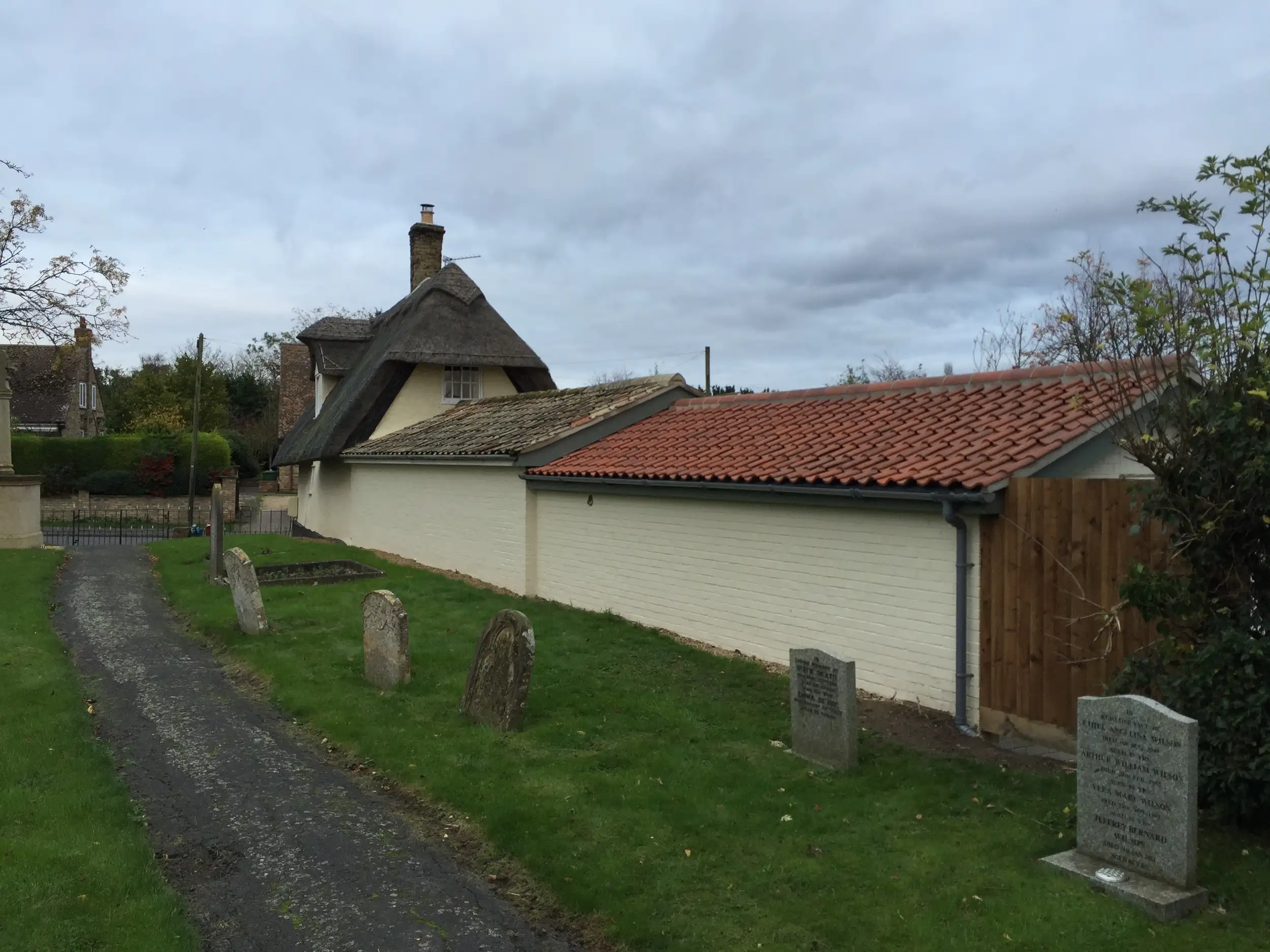 Completed outbuilding in a churchyard setting
